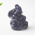 Close-up of sparkling blue sandstone elephant figurine on a neutral textured background - Blue Sandstone