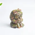 Macro detail of hand-carved unakite crystal cat figurine with natural green and pink texture - Unakite