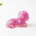 Macro shot of a pink natural crystal stone resin dog ornament on a white background - Rose Red Crystal