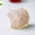 Macro shot of a pink crystal cat figurine with detailed texture and translucent finish - Rose Quartz