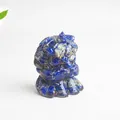 Detailed macro view of deep blue lapis lazuli resin lion statue with a white background - Lapis Lazuli