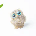 Natural crystal owl resin figurine with black stones and gold flakes on white background - Rutilated Quartz