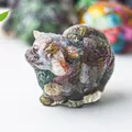 Macro shot of cat figurine with colorful crystal stones in resin for desk decoration - Ocean Jasper
