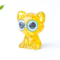 Translucent yellow resin cat figurine with blue eyes and natural crystal texture - Citrine