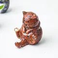 Vista macro di statuetta a gatto in resina con riempimento di pietre naturali rosse - Diaspro Rosso