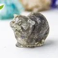 Macro detail of hand-carved natural crystal cat figurine with realistic stone texture - Labradorite