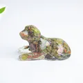 Lying dog figurine crafted from natural green and red crystal chips in transparent resin - Unakite