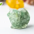 Close-up of a translucent light green crystal cat figurine with detailed fur texture - Green Aventurine