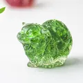 Macro detail of a green translucent crystal cat figurine with fine fur texture carvings - Emerald Glaze