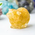 Macro shot of amber resin cat figurine showing translucent texture and fine crystal details - Yellow Agate