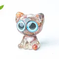 Cat ornament with natural multicolor crystals and resin featuring large blue eyes - Red Agate