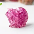 Macro shot of pink crystal resin cat statue with detailed natural stone texture - Rose Red Crystal