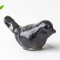Minimalist black resin bird figurine with a glossy finish for home office decor - Obsidian