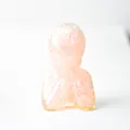 Minimalist pink rose quartz resin figurine in a meditative praying posture - Rose Quartz