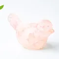 Pink resin crystal bird figurine with natural ice crack texture on white background - Rose Quartz