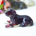Lying puppy ornament made of dark red crystal resin with garnet-like texture - Garnet