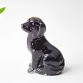 Polished black resin puppy figurine with obsidian-like finish and carved textures - Obsidian