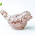 Artistic bird figurine crafted from translucent resin filled with pink natural quartz stones - Strawberry Quartz