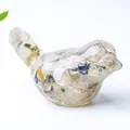 Artistic bird figurine made of clear resin with natural colorful crystal stone chips - Rutilated Quartz