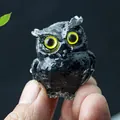 Glossy black resin owl figurine with vivid yellow eyes and polished finish - Obsidian