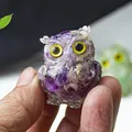 Purple resin crystal owl figurine with yellow eyes held in hand as a desk ornament - Dreamy Purple