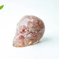 Pink natural crystal skull ornament made of transparent resin with gemstone chips - Strawberry Quartz