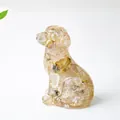 Transparent sitting puppy statue made of resin with dried green plants and flower petals - Rutilated Quartz