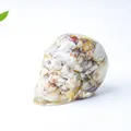 Skull figurine made of transparent resin filled with natural white and red crystal stones - Crazy Agate