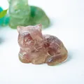 Macro shot of amber resin cat figurine showing detailed fur texture and translucent finish - Strawberry Quartz