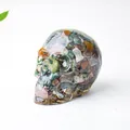 Crystal skull ornament featuring colorful natural stones embedded in clear resin - Ocean Jasper