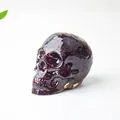 Skull figurine made of transparent resin filled with natural deep red crystal gravel - Garnet