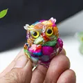 Miniature resin owl ornament with colorful natural crystal stone inlay held in hand - Colorful Shell