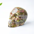 Artistic skull figurine made of resin with natural green and pink Unakite crystal stones - Unakite
