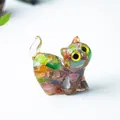 Détail d'une figurine de chat en cristal fait main avec incrustations de pierres colorées - Œil de Chat Coloré