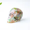 Skull figurine made of multi-color natural crystal stones and clear resin - Colorful Cat Eye