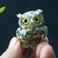 Mini resin owl statue with colorful natural crystals held by hand for size context - Ocean Jasper