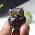 Miniature purple resin owl statue with yellow eyes and textured crystal surface - Garnet