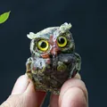 Miniature resin owl statue with colorful crystal stones and vibrant yellow eyes - Dragon Blood Stone