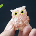 Pink resin owl figurine with natural crystal stone inlay held in hand for size - Watermelon Quartz