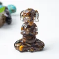 Meditating dog figurine with tiger eye stone chips embedded in clear resin - Tiger's Eye