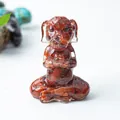 Meditating dog figurine with embedded reddish-brown natural stone in clear resin - Red Jasper