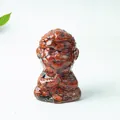 Meditating monkey figurine crafted with red crystal chips and clear resin for desk decor - Red Jasper