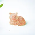 Miniature cat figurine carved from translucent orange sunstone crystal for home decor - Watermelon Quartz