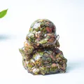 Laughing Buddha statue made of clear resin with colorful crushed natural crystals and gold ingot - Unakite