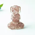 Meditating dog statue carved from strawberry crystal with a serene zen prayer pose - Strawberry Quartz
