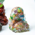 Laughing Buddha statue crafted from resin with colorful natural crystal stone inlay - Colorful Cat Eye