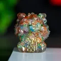 Macro shot of colorful crystal resin lion statue with golden prosperity characters - Colorful Cat Eye