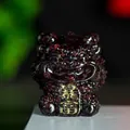 Translucent red crystal guardian lion figurine with gold charm inscribed Fortune - Garnet