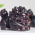 Macro detail of a translucent dark red resin dragon turtle ornament with fine carving - Garnet