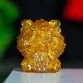 Amber crystal lion figurine holding a lucky charm for wealth and prosperity - Citrine